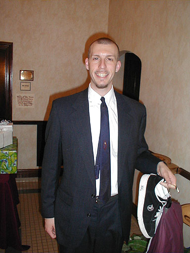 Brian W Root Standing in suit after a wedding.